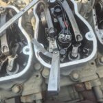 Precision valve adjustment on Scania engine for peak performance and efficiency.